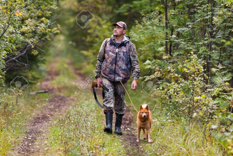Охотник с собакой в лесу
